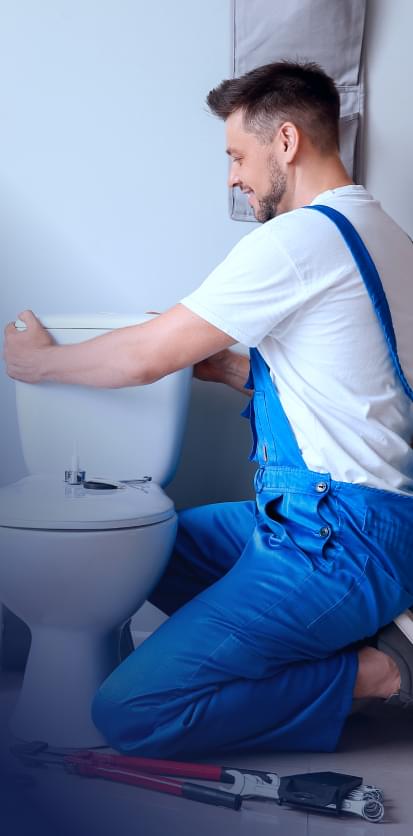 HomePro worker repairing a toilet.